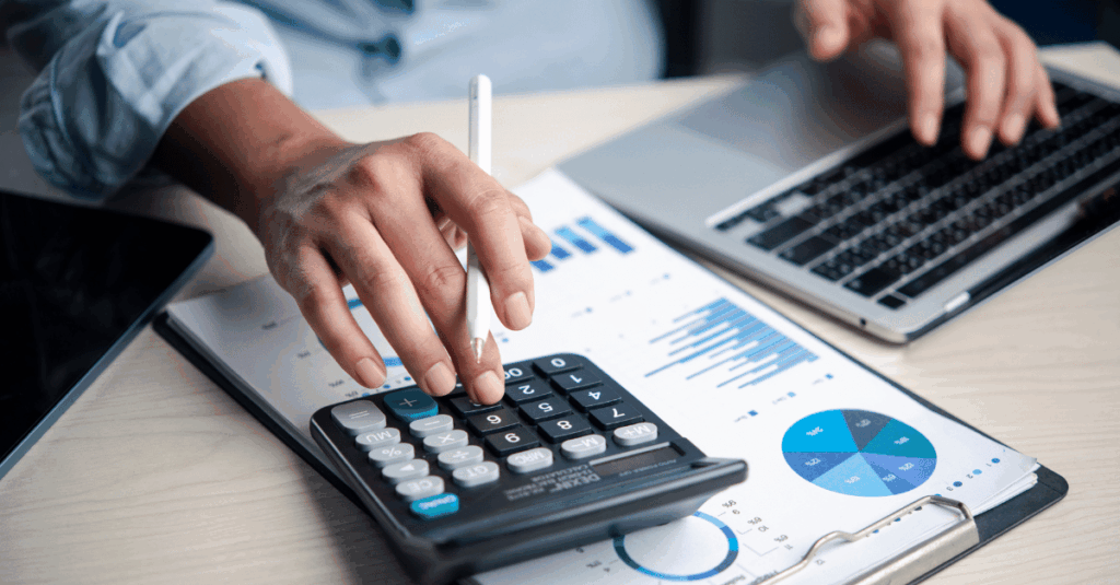 Business owner calculating profit margin with charts and tools to optimize pricing, expenses, and profitability